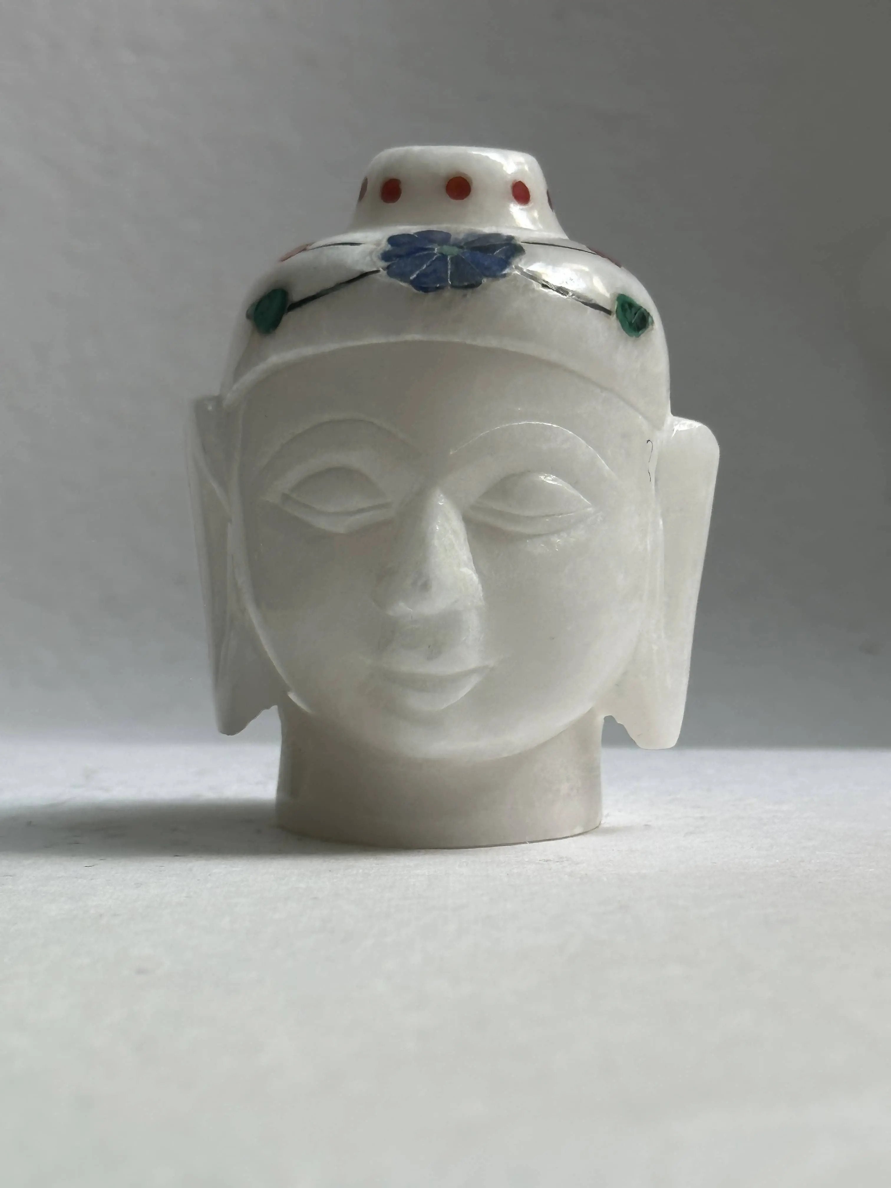 White Marble Buddha head - There is nothing more soothing for your living space than having a Buddha statue as home decor. This particular White marble example depicts the head of Buddha in his meditative state and has been made using fine marble.