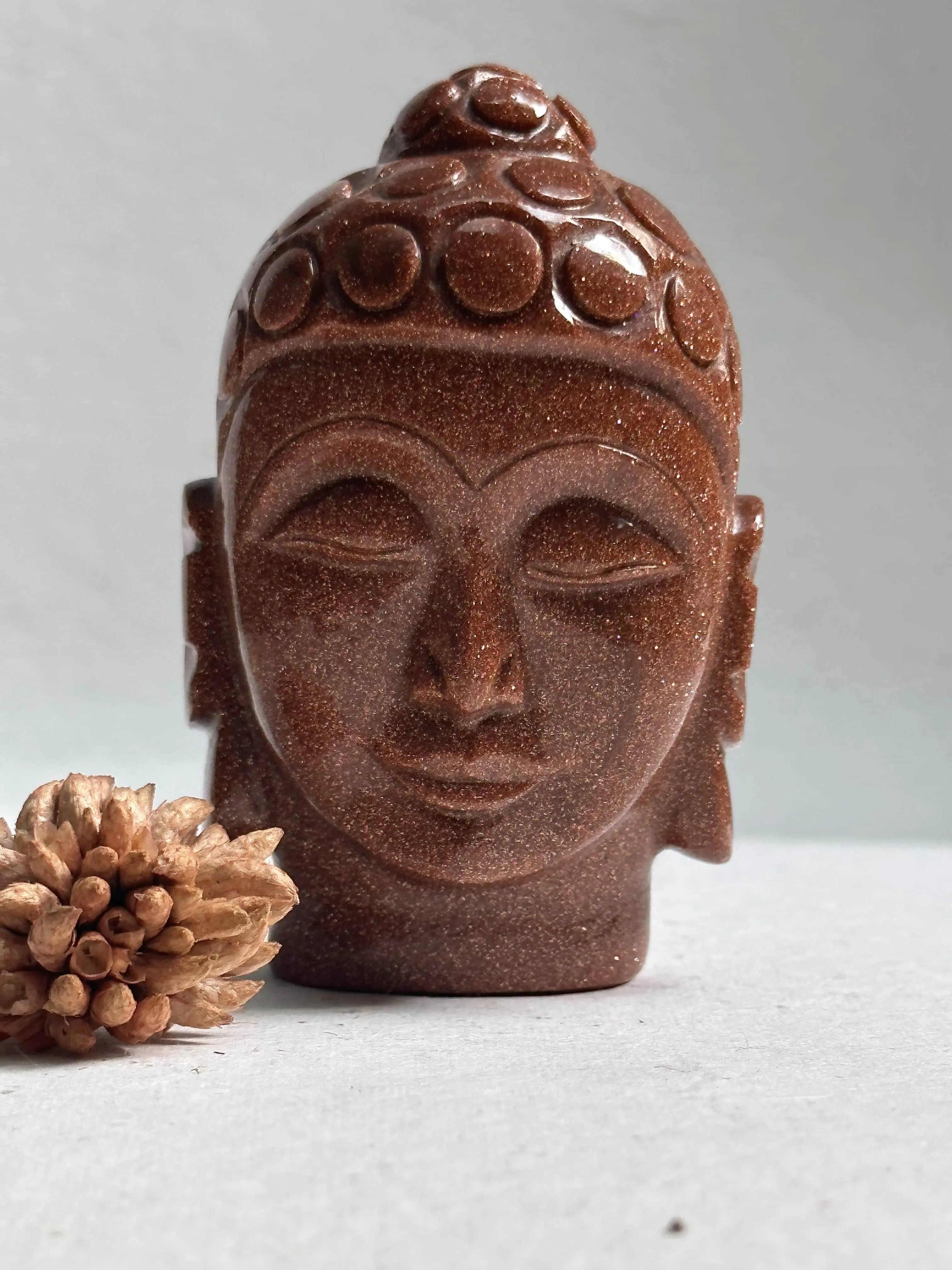 Sparkle of the Universe- Red Gold Stone Buddha face - Encourages a positive attitude, it is an uplifting stone, Goldstone is said to promote vitality, and help to lift anxious people to a happier mindset